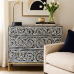Elegant black Sheesham wood chest of drawers with intricate white bone inlay vine pattern and golden legs