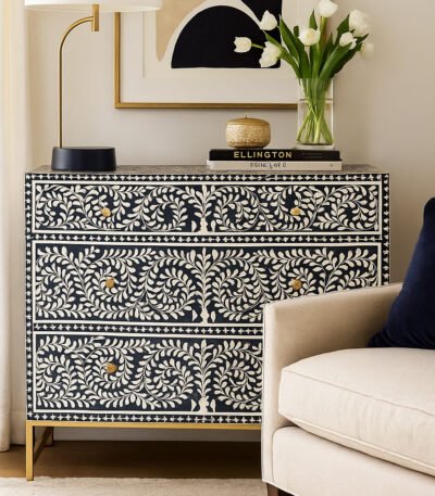 Elegant black Sheesham wood chest of drawers with intricate white bone inlay vine pattern and golden legs