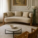 Contemporary handcrafted mango wood sofa with curved backrest, minimalist frame, and cozy fabric cushions