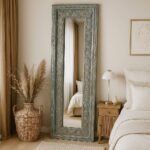 Tall vintage-style Sheesham wood mirror with detailed handcarved floral patterns, ideal as a statement hallway or dressing mirror.
